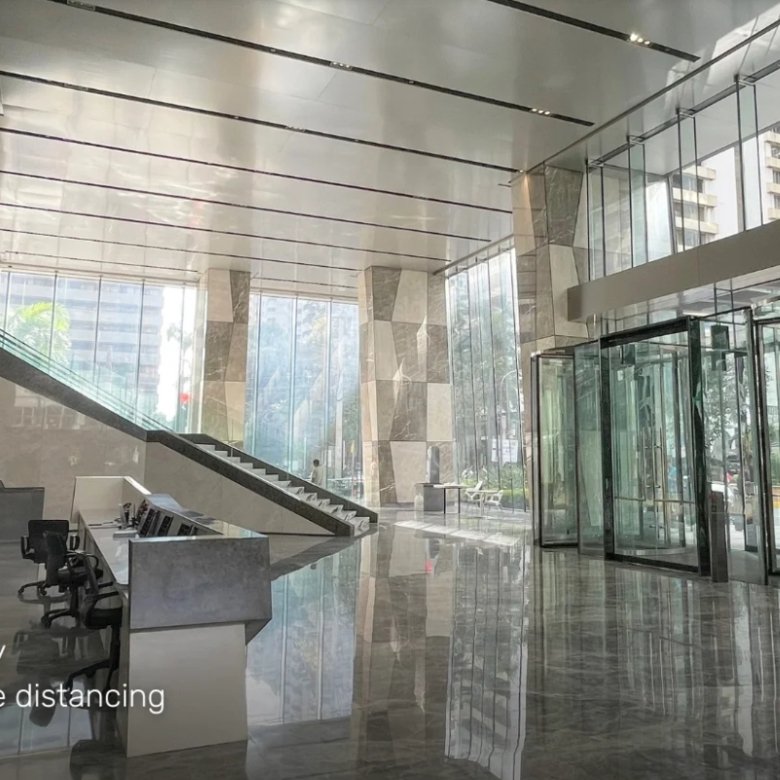 Grand Lobby interior with marble floors and crystal revolving doors; overlay text reads 'Grand Lobby' and descriptions of height and distancing.