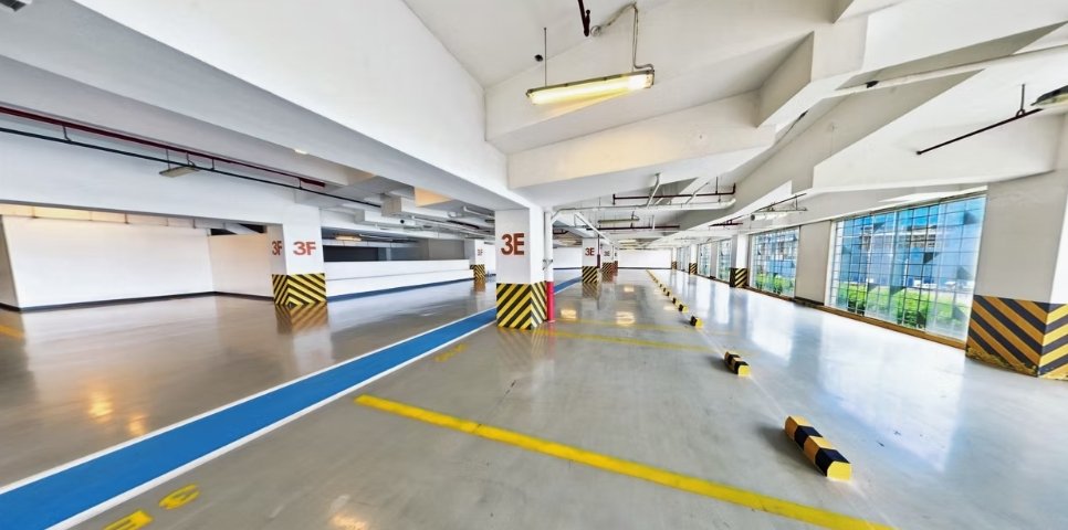 Essence: an empty multi-level parking garage with blue driving lane, yellow lane marks, and striped pillars labeled 3F on white columns.